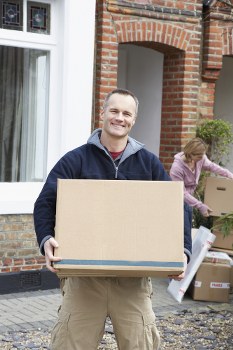 Removal team handling furniture in a Kensington apartment building