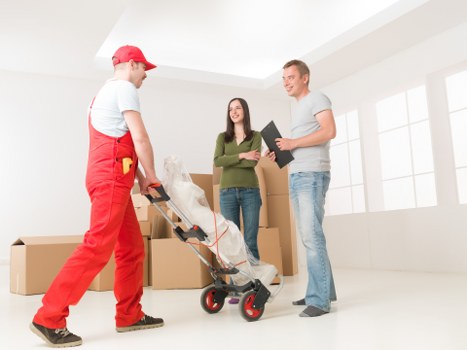 Packed boxes and furniture prepared for transport in a Kensington home move